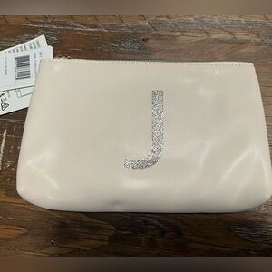 Jade & Deer charging wallet off white with a sparkly J and tassel zipper open